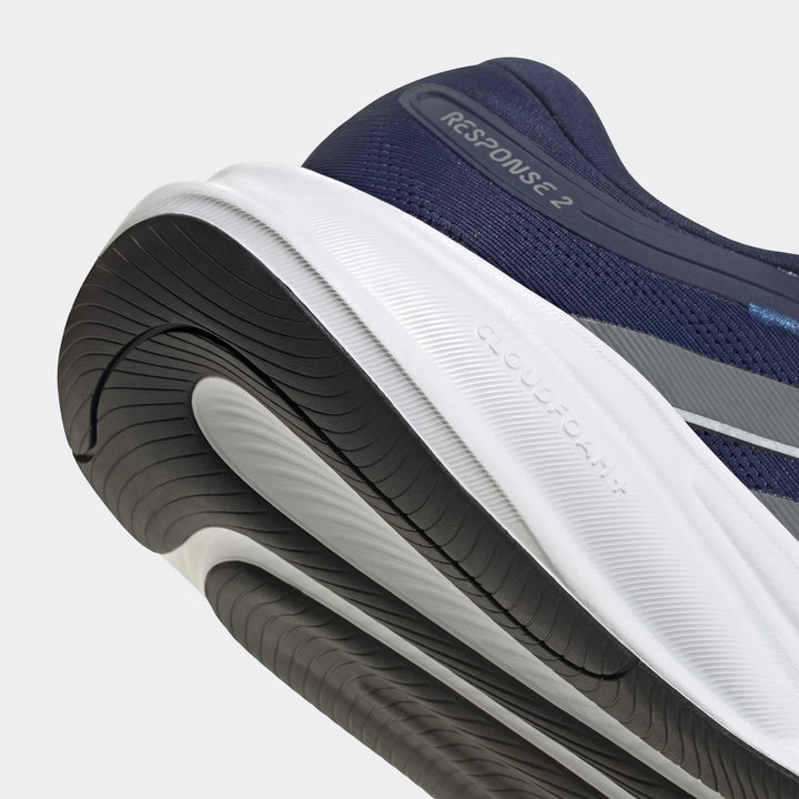 Close-up view of the navy blue and white Response 2 Running Shoes, highlighting the textured Cloudfoam sole and heel design.