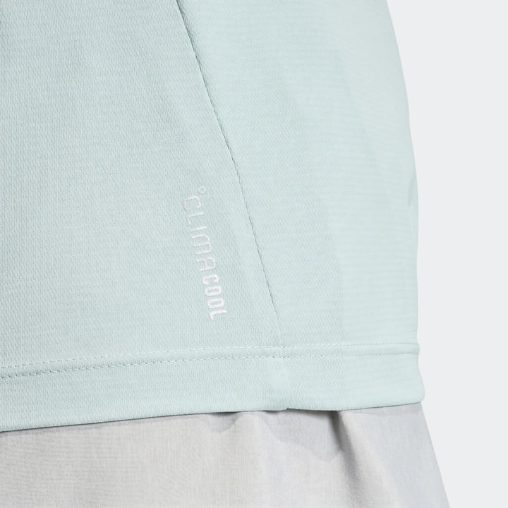 Close-up of a light blue Run Essentials T-Shirt featuring a 'CLIMACOOL' logo, showcasing the athletic fabric and subtle