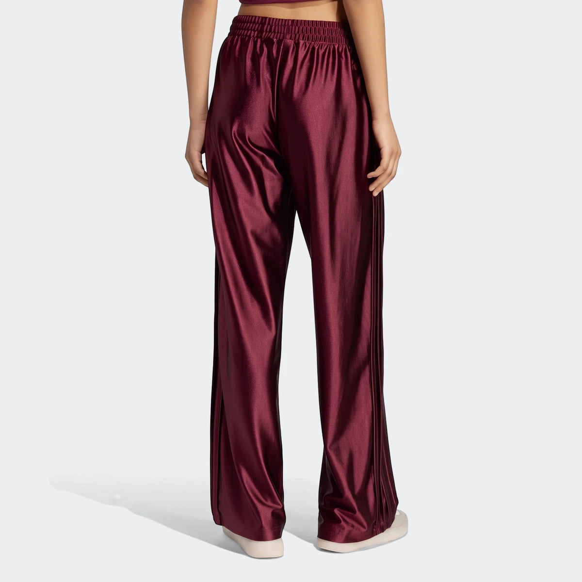 Seasonal Essentials satin tracksuit bottoms in maroon, viewed from the back, showcasing the full length on a female model.