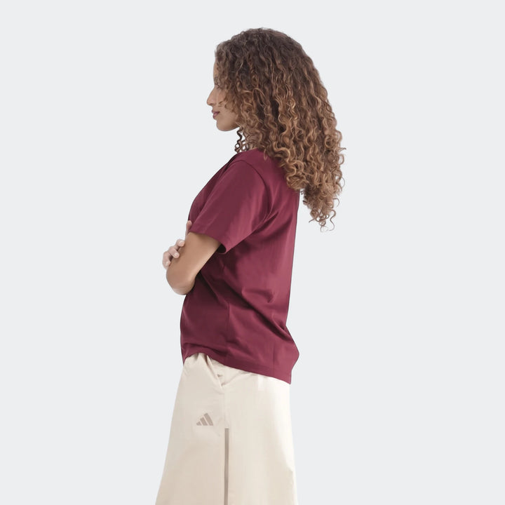 Maroon Slim Single Jersey T-Shirt on a woman with curly hair, shown in a side profile view, highlighting the short-sleeve
