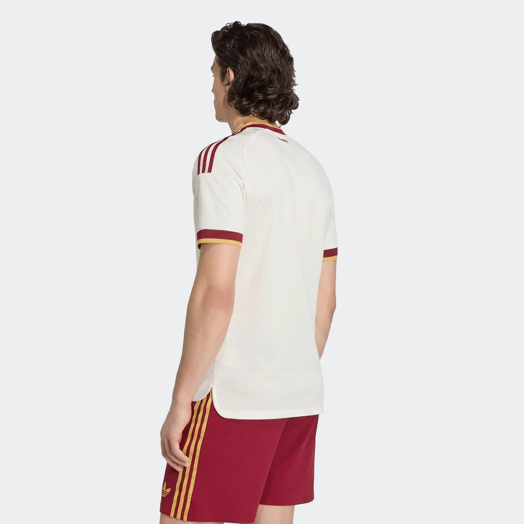 Men's white Spain 25/26 Authentic Away Jersey with maroon and yellow details, worn by a model from the back, paired with