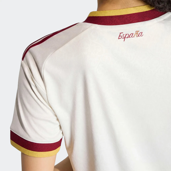 Back view of a women's Spain 25/26 Away Jersey in white, featuring red and yellow collar details, red shoulder stripes, and
