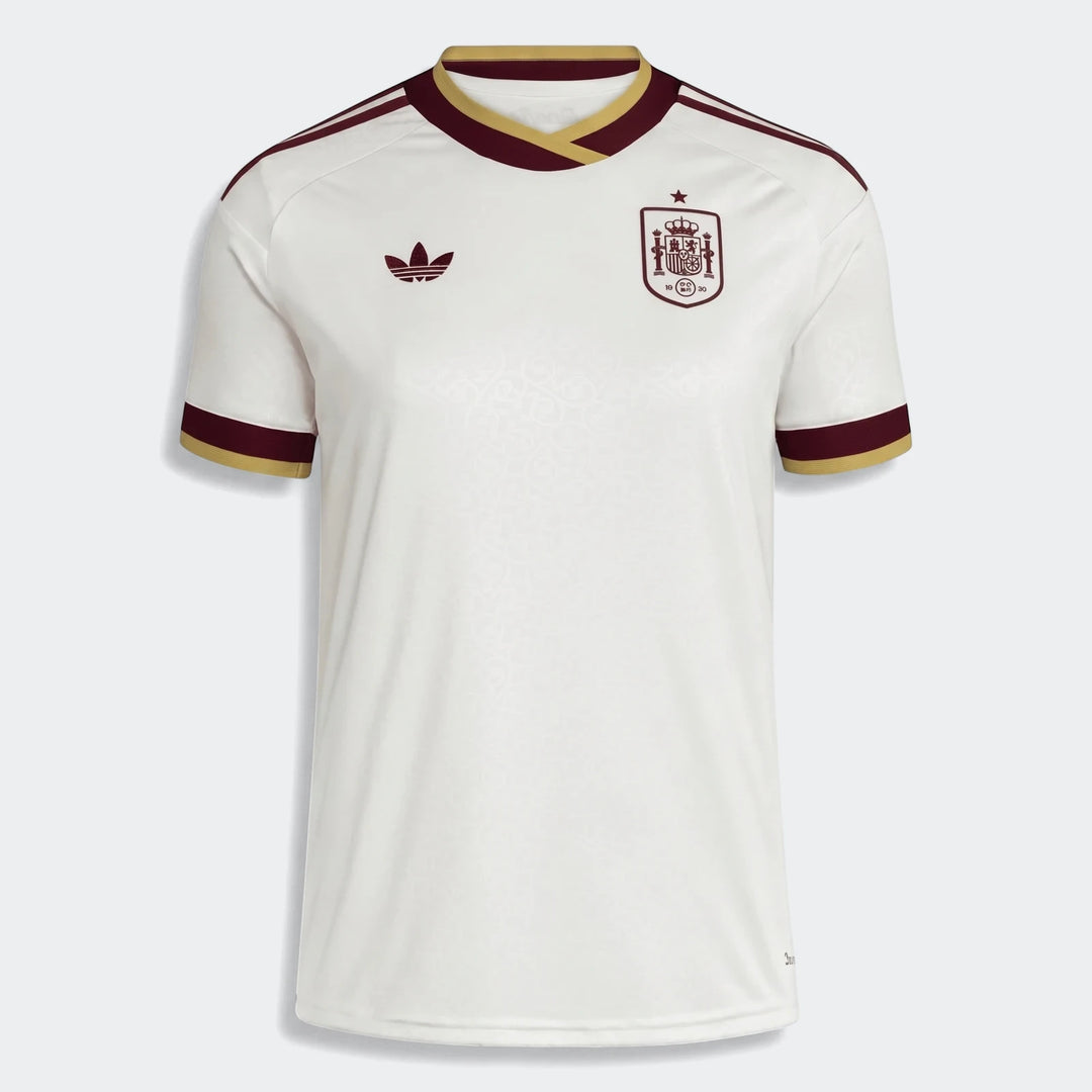 Women's Spain 25/26 away jersey in white with maroon and gold trim, featuring an Adidas logo and national crest.