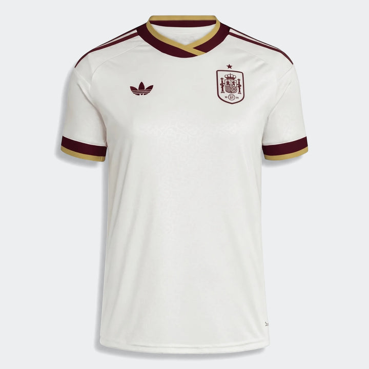 Women's Spain 25/26 away jersey in white with maroon and gold trim, featuring an Adidas logo and national crest.