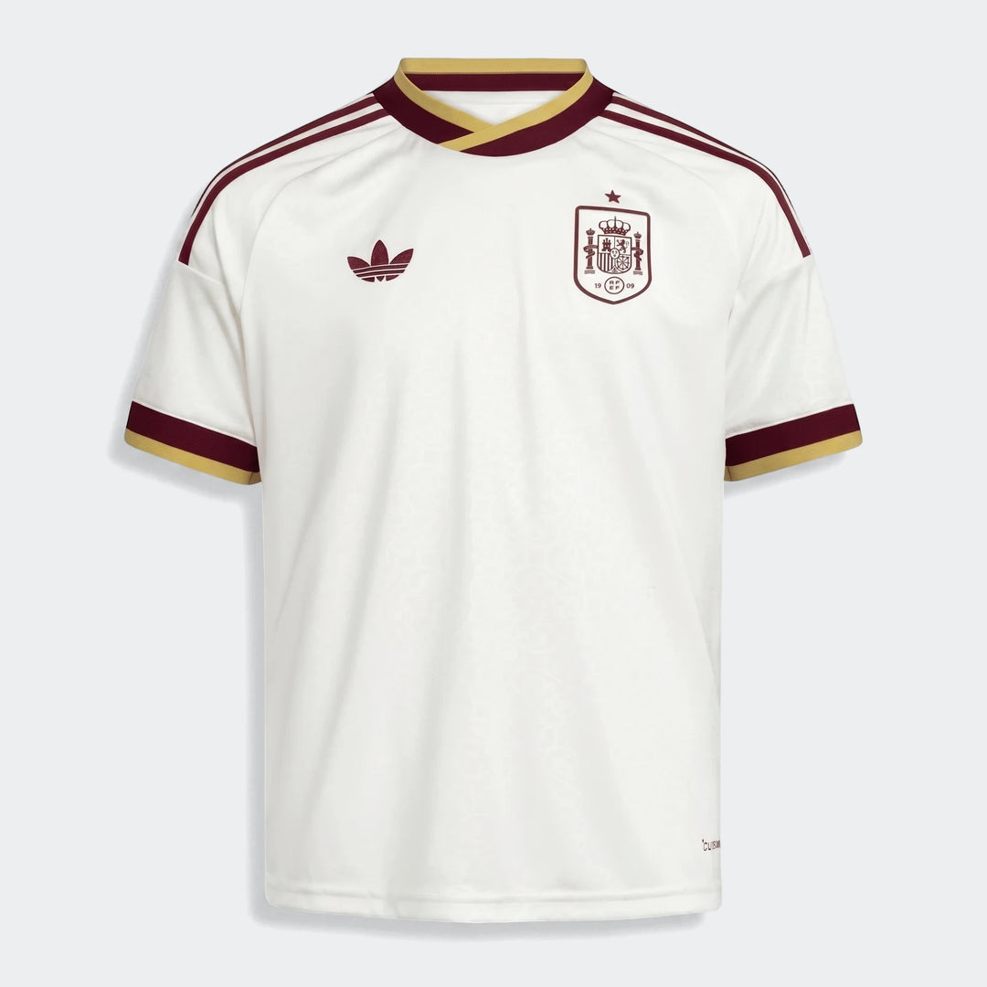 Front view of the Spain 25/26 Away Jersey Youth. White jersey with maroon and gold trim, team crest, and Adidas logo.