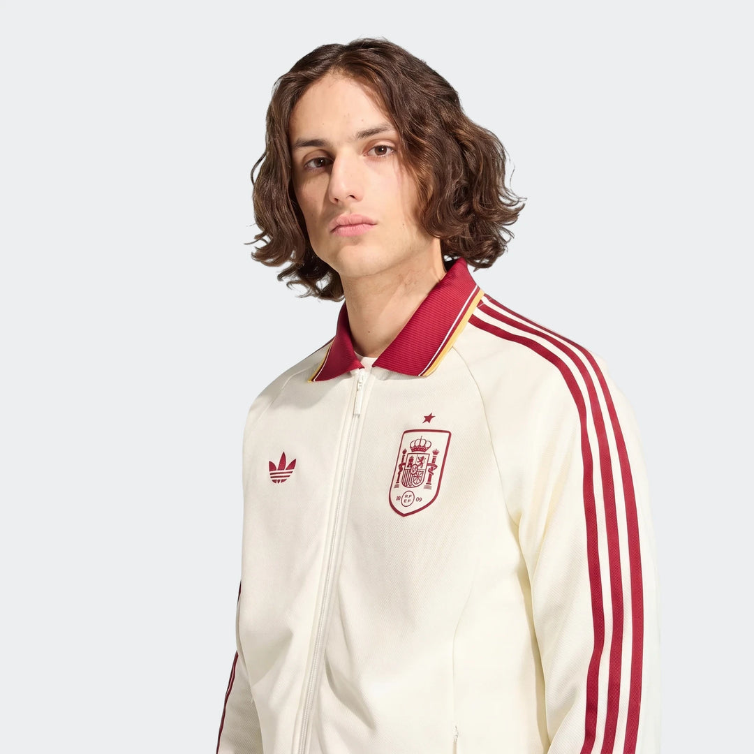 Spain Away Anthem Jacket in off-white with burgundy and yellow details, worn by a male model, chest-up view.