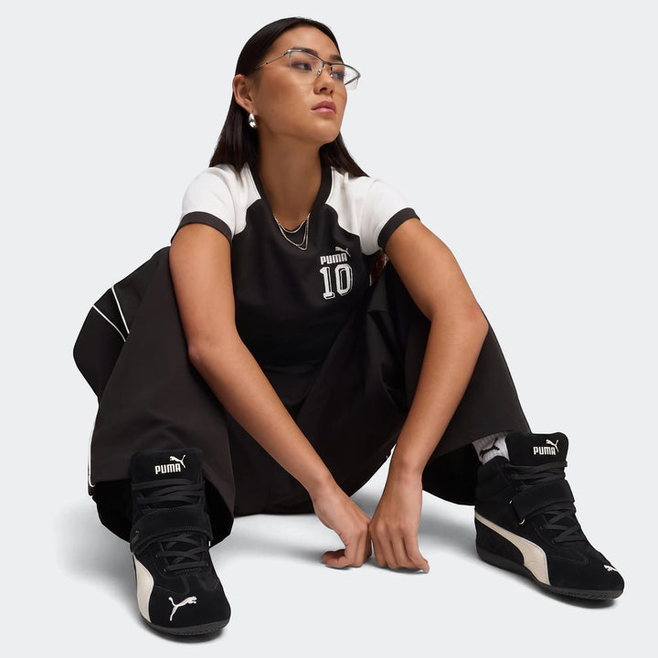 Speedcat Wedge Og Sneakers Women, black and white suede high-top sneakers, worn by a model in a seated pose.