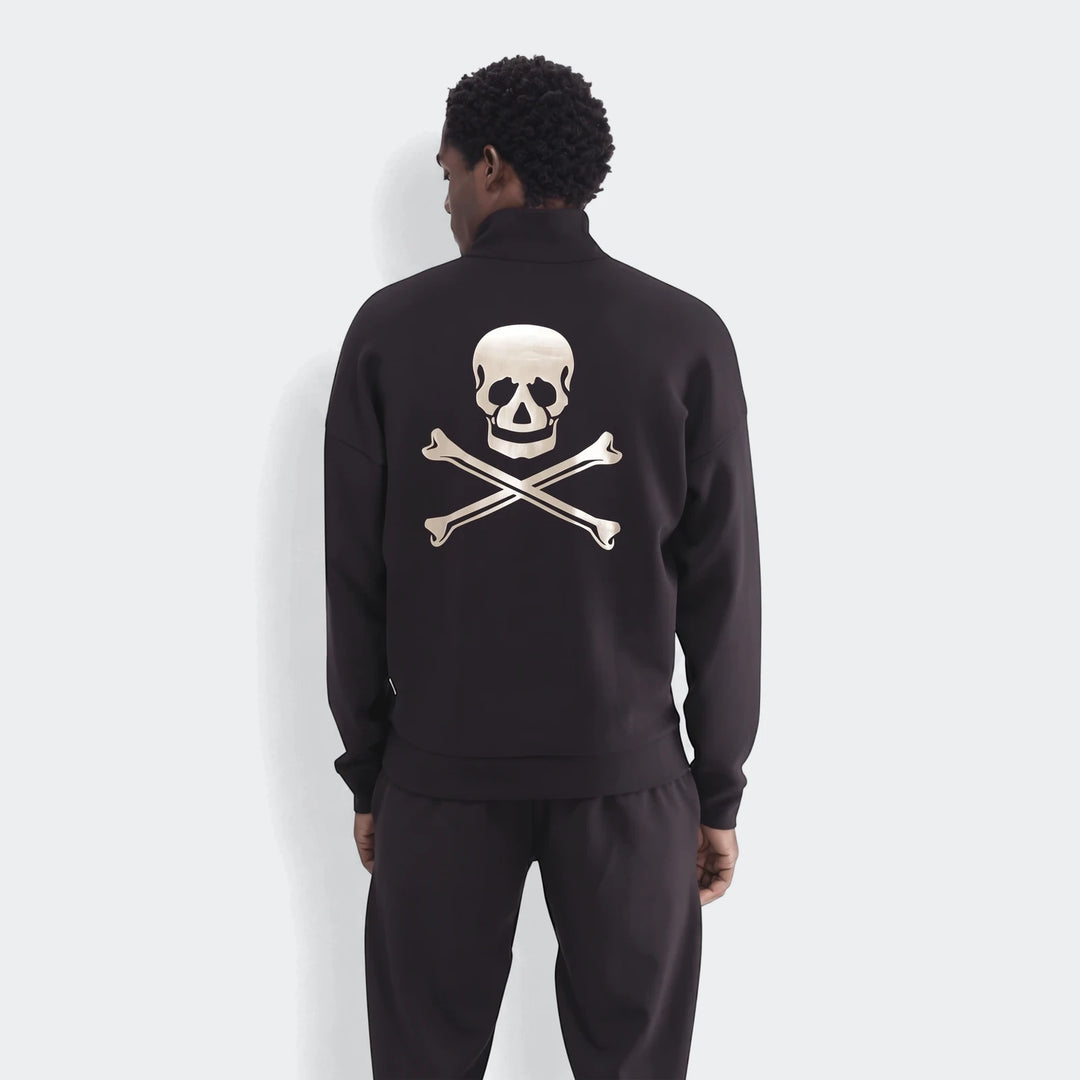 Back view of a man wearing a black Sportswear Open Hem Future Icons Half-Zip Sweatshirt with a metallic skull and crossbones
