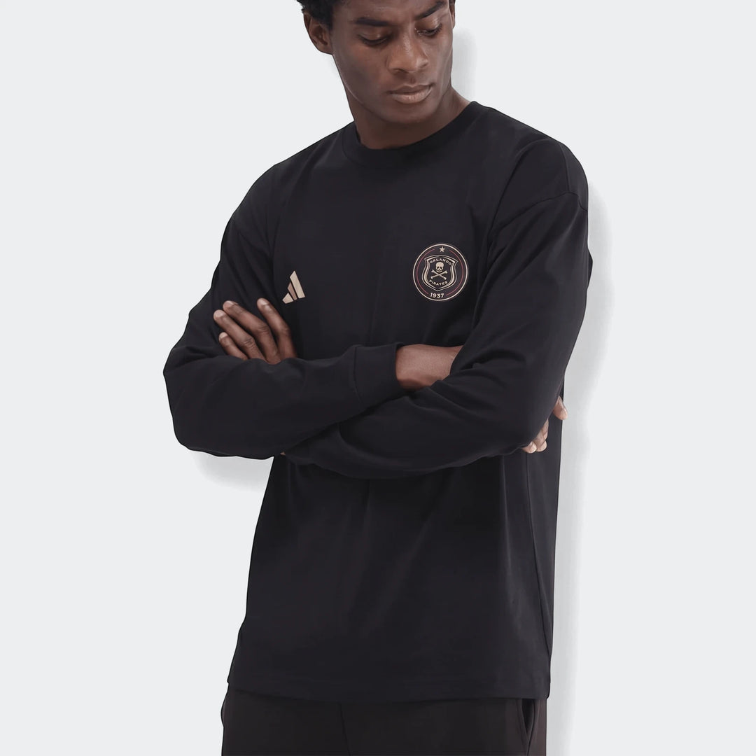 Black Sportswear Open Hem Essentials+ Slim Long Sleeve T-Shirt worn by a male model with arms crossed, featuring gold logos.