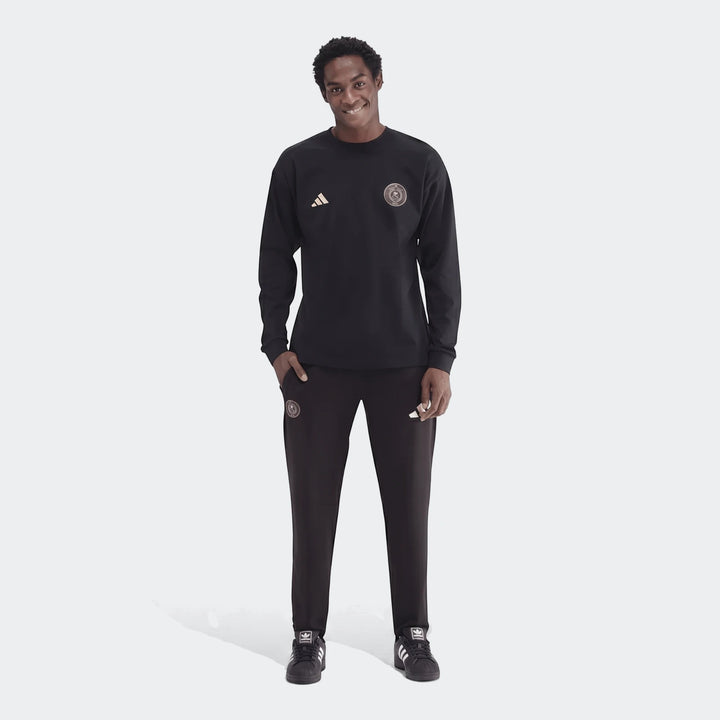 Men's black Sportswear Open Hem Essentials+ Slim Long Sleeve T-Shirt and track pants on a model, full view.