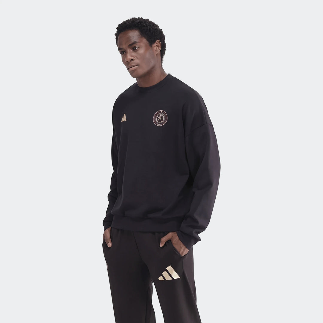 Male model wearing a black Sportswear Open Hem Future Icons 3-Bar Crew Sweatshirt and matching sweatpants with gold logos,