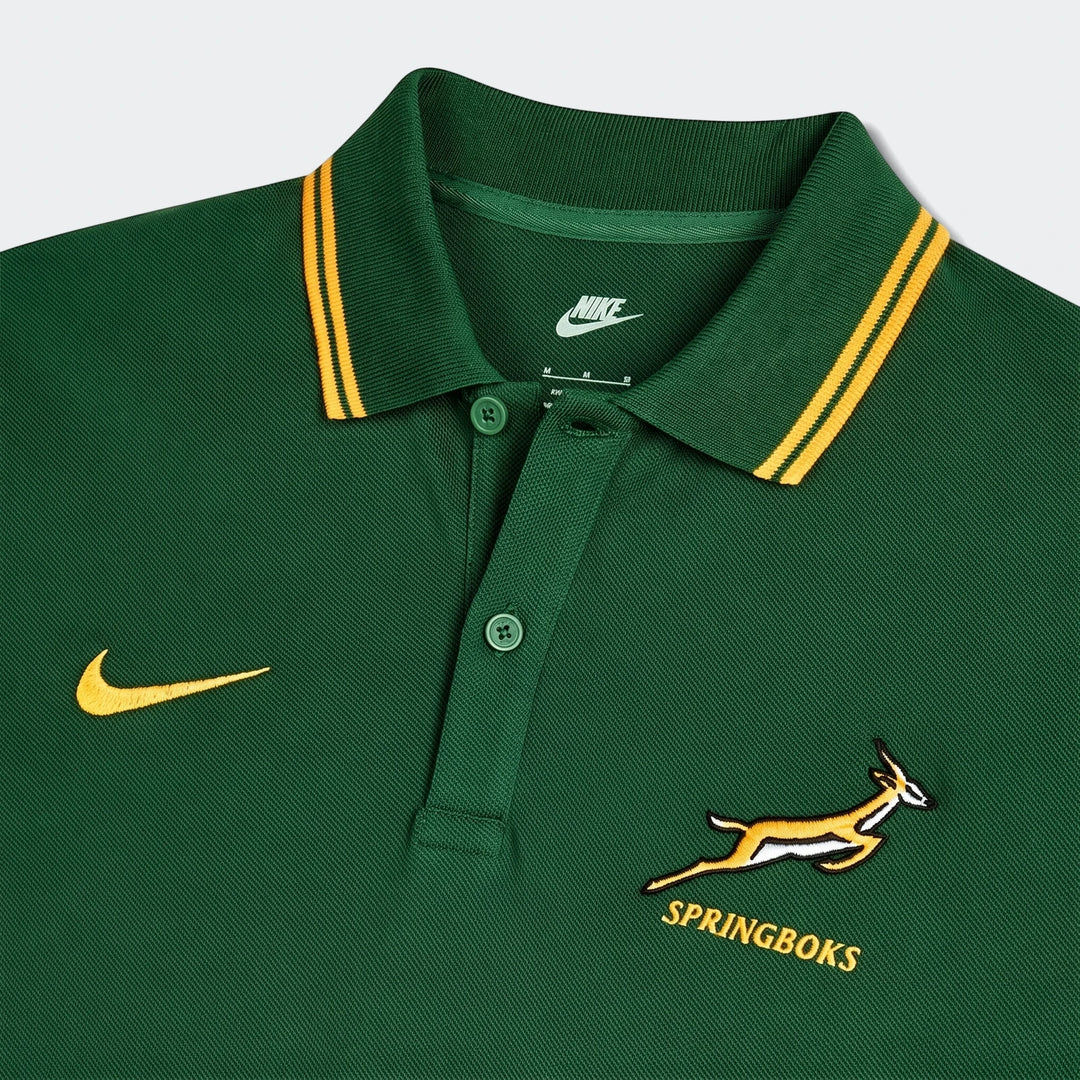 Close-up of a dark green Nike Springboks pique polo shirt, featuring embroidered Nike swoosh and Springbok logo, with a
