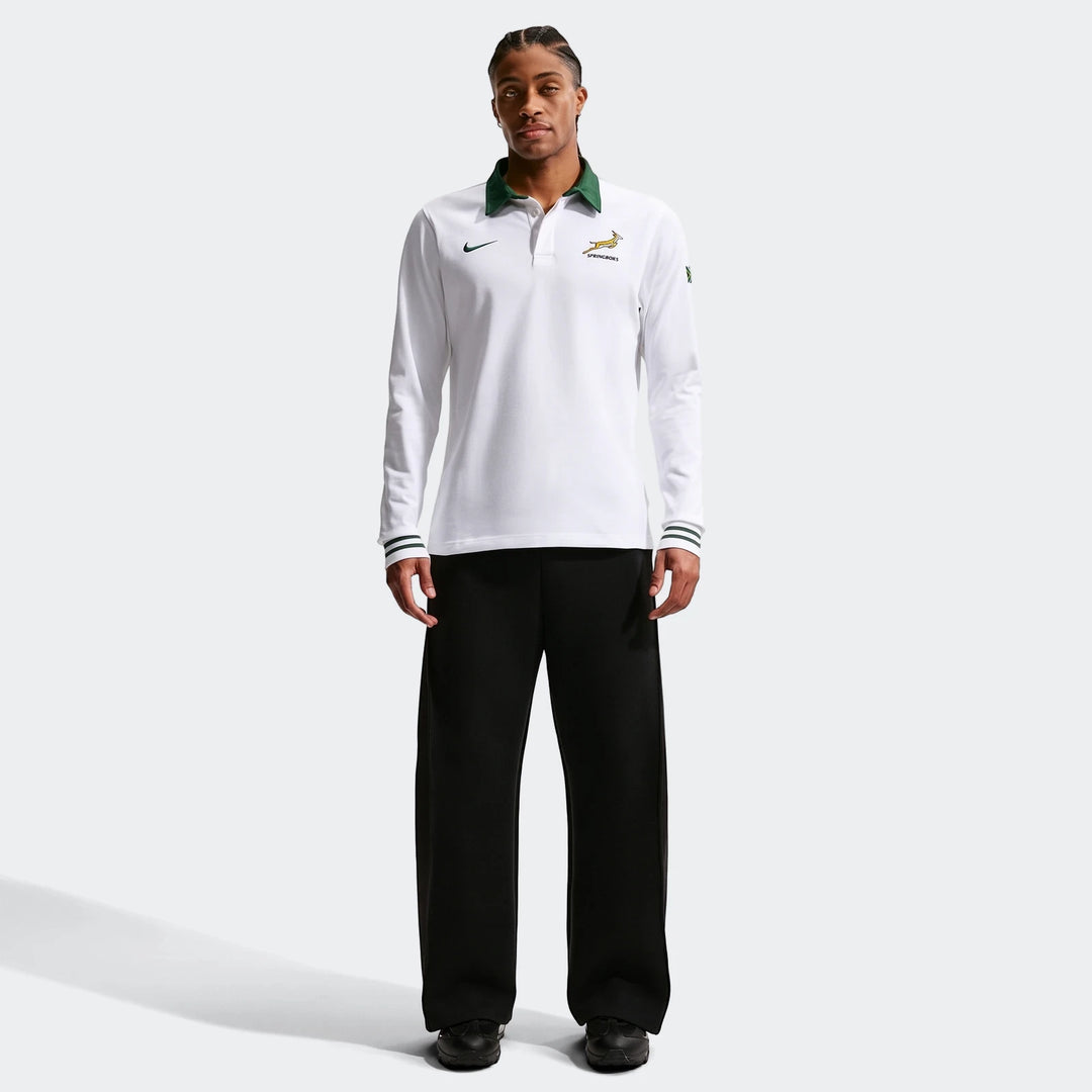 White Springboks Away Mens Nike Long Sleeve Rugby Jersey with a green collar worn by a male model, styled with black pants.
