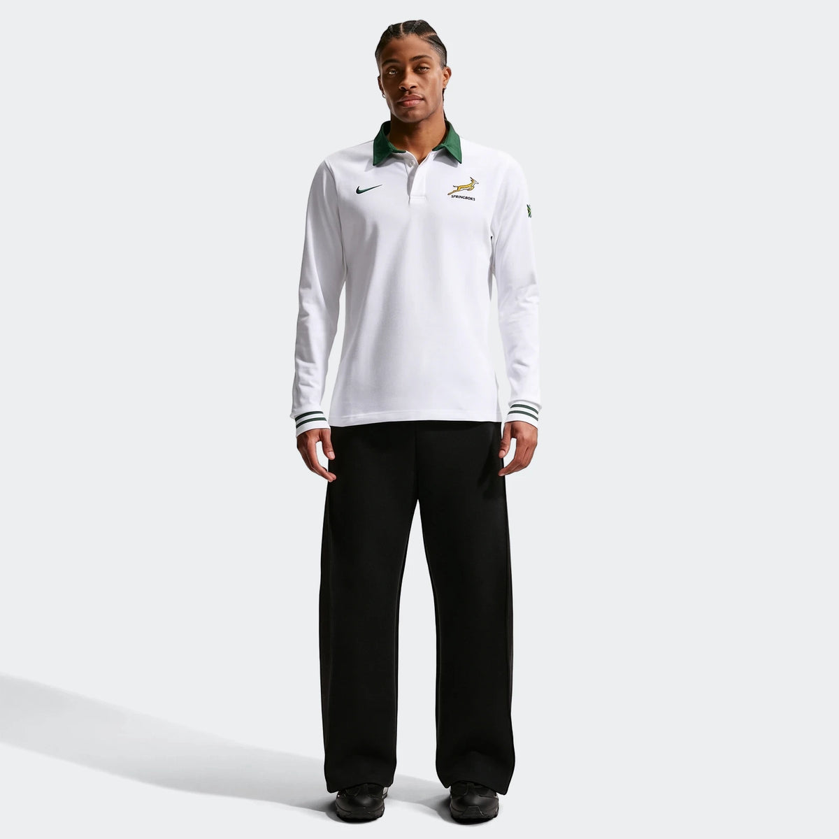 White Springboks Away Mens Nike Long Sleeve Rugby Jersey with a green collar worn by a male model, styled with black pants.