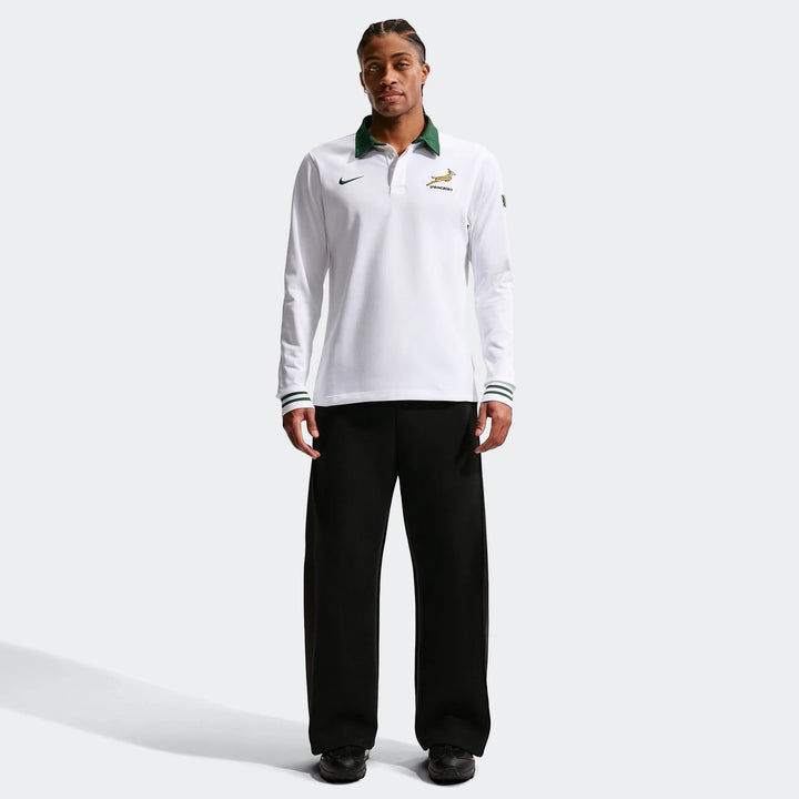 White Springboks Away Mens Nike Long Sleeve Rugby Jersey with a green collar worn by a male model, styled with black pants.