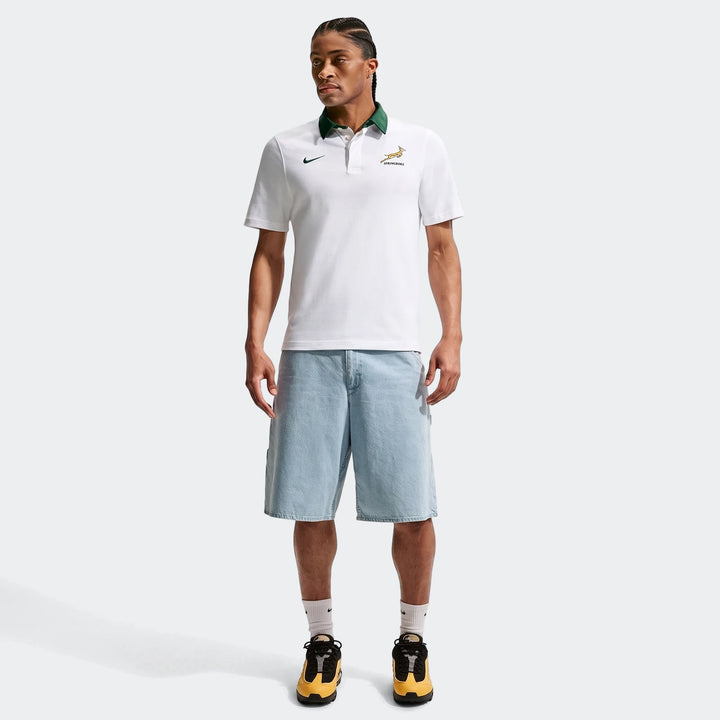 Men's Springboks Away Nike Rugby Jersey in white with a green collar, worn by a model with light blue denim shorts.