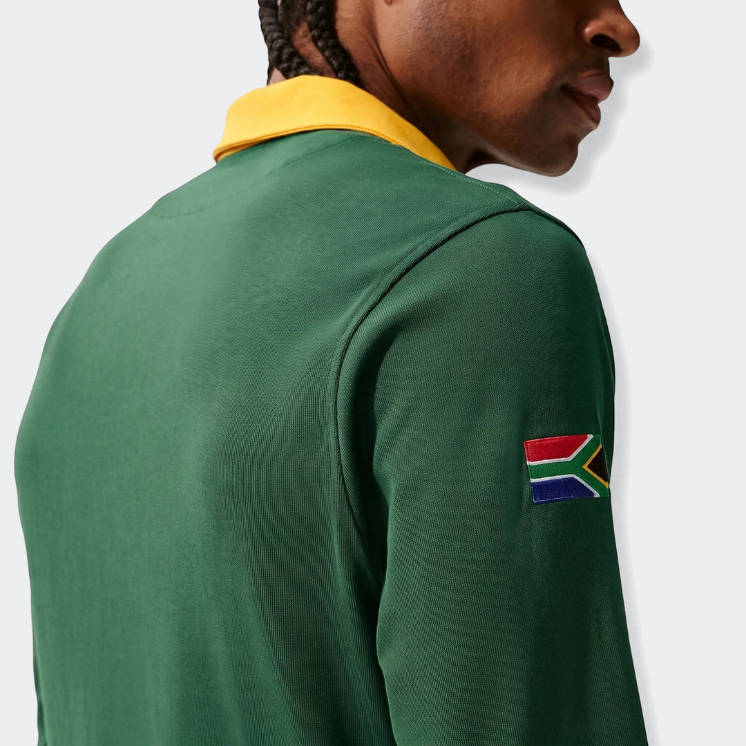 Close-up back view of a man wearing a green Springboks Home Nike long-sleeve rugby jersey with a yellow collar and South