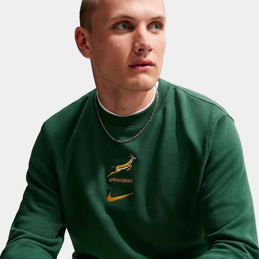 Springboks Men's French Terry Crewneck Sweatshirt in dark green, featuring the Springboks logo and a Nike swoosh, worn by a