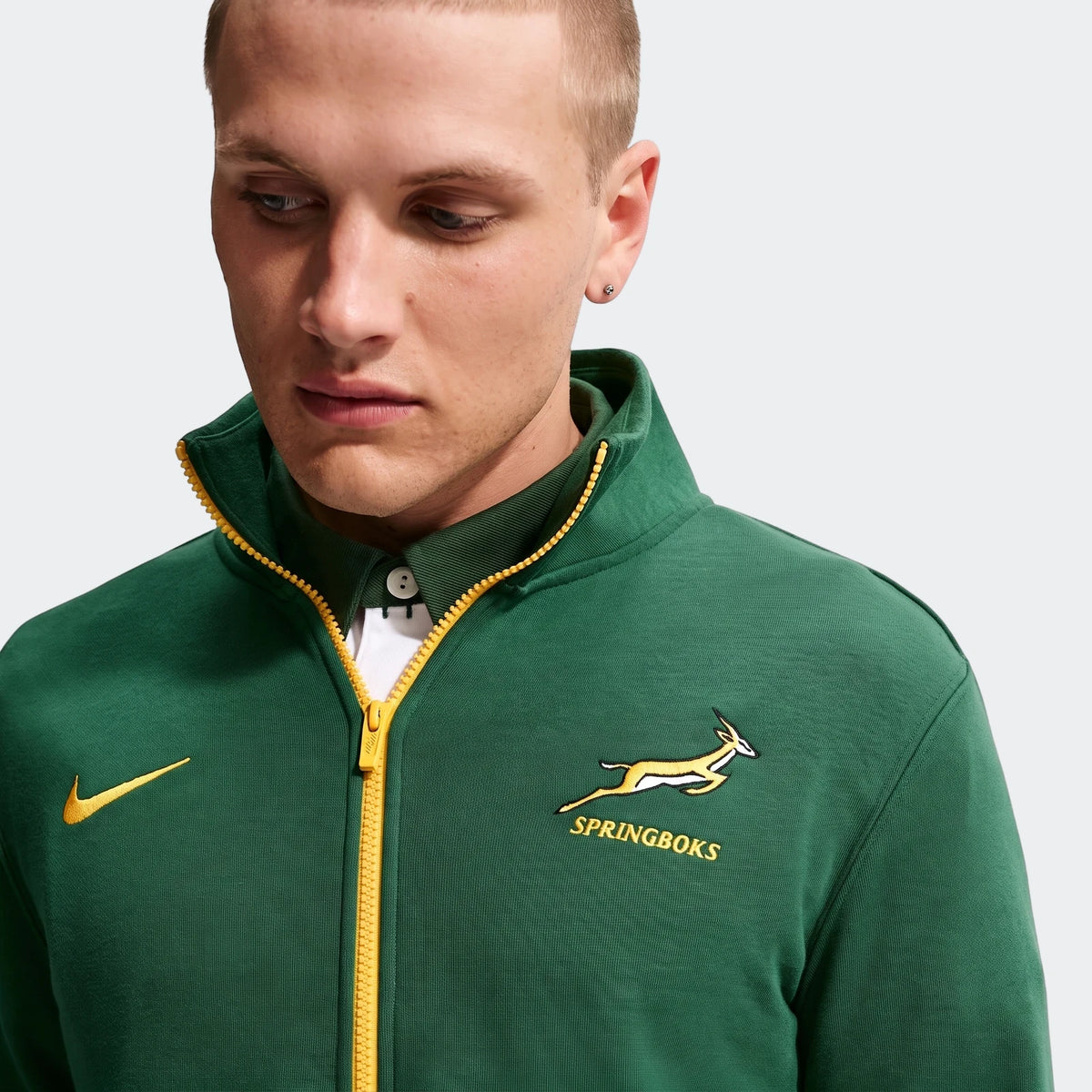 Springboks Men's Nike 1/2 zip sweater in green with yellow zipper and Springboks logo, worn by a man.