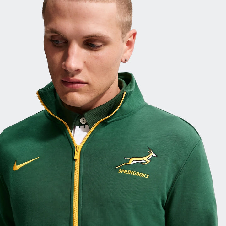Springboks Men's Nike 1/2 zip sweater in green with yellow zipper and Springboks logo, worn by a man.