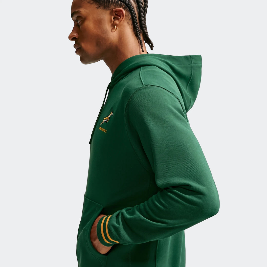 Men's dark green Springboks Nike hoodie with an embroidered springbok logo, worn by a man in profile with his hand in the
