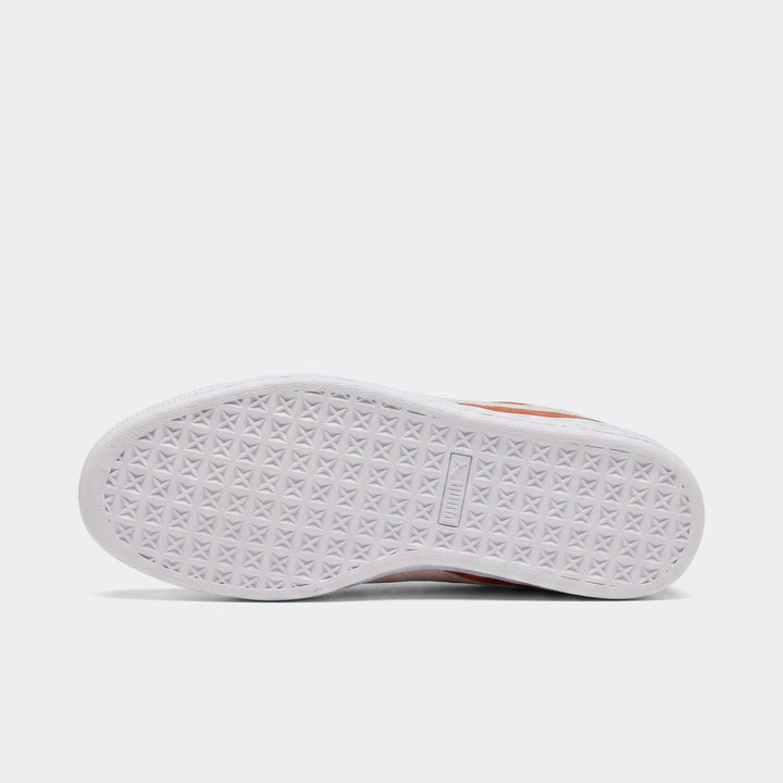 Bottom view of a Suede Classic Cayenne Pepper/White sneaker, showcasing its textured white rubber sole with visible branding.