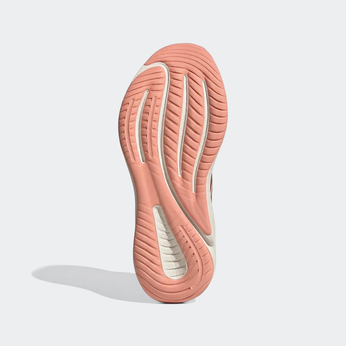 Bottom view of Supernova Ease 2 Running Shoes, showcasing the pink and off-white textured sole for grip and comfort.