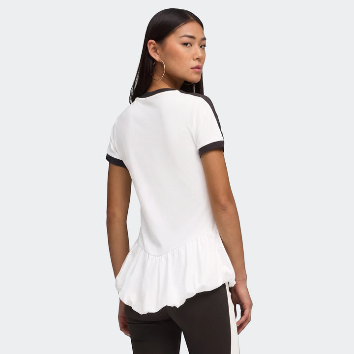 Woman facing away, looking over shoulder, wearing a white T7 Balloon Crew Neck Short Sleeve T-Shirt with black stripes and a
