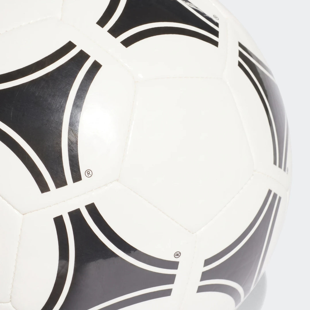Close-up of a white Tango Glider soccer ball, size 3, featuring black abstract patterns and visible stitching on its surface.