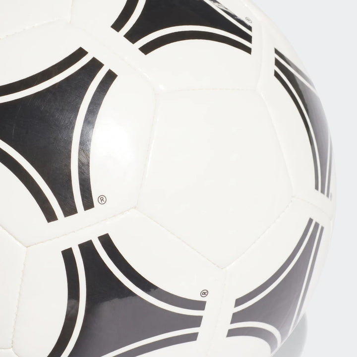 Close-up of a white Tango Glider soccer ball, size 3, featuring black abstract patterns and visible stitching on its surface.