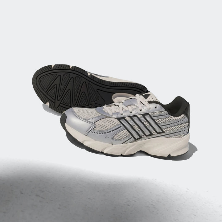 Silver, white, and black mesh Technochaos 2000 running shoes, featuring detailed sole patterns and stripe branding.