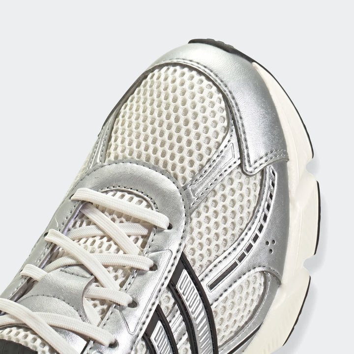 Close-up view of the front of silver and white Technochaos 2000 shoes, featuring mesh and metallic overlays.