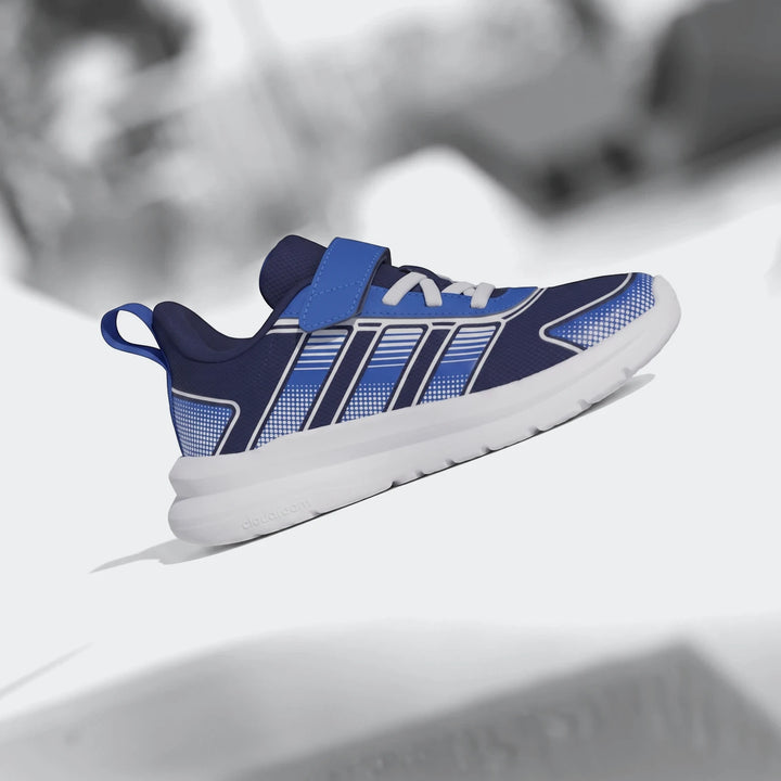 Navy blue and royal blue Tensaur Run 4.0 children's athletic shoe with white sole and Velcro strap, side view.