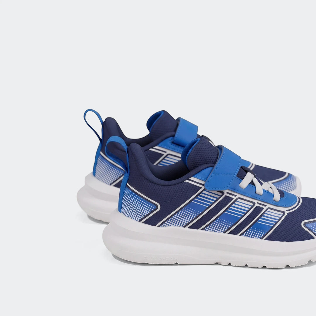 A pair of navy blue, royal blue, and white Adidas Tensaur Run 4.0 children's shoes with hook-and-loop closure shown on an
