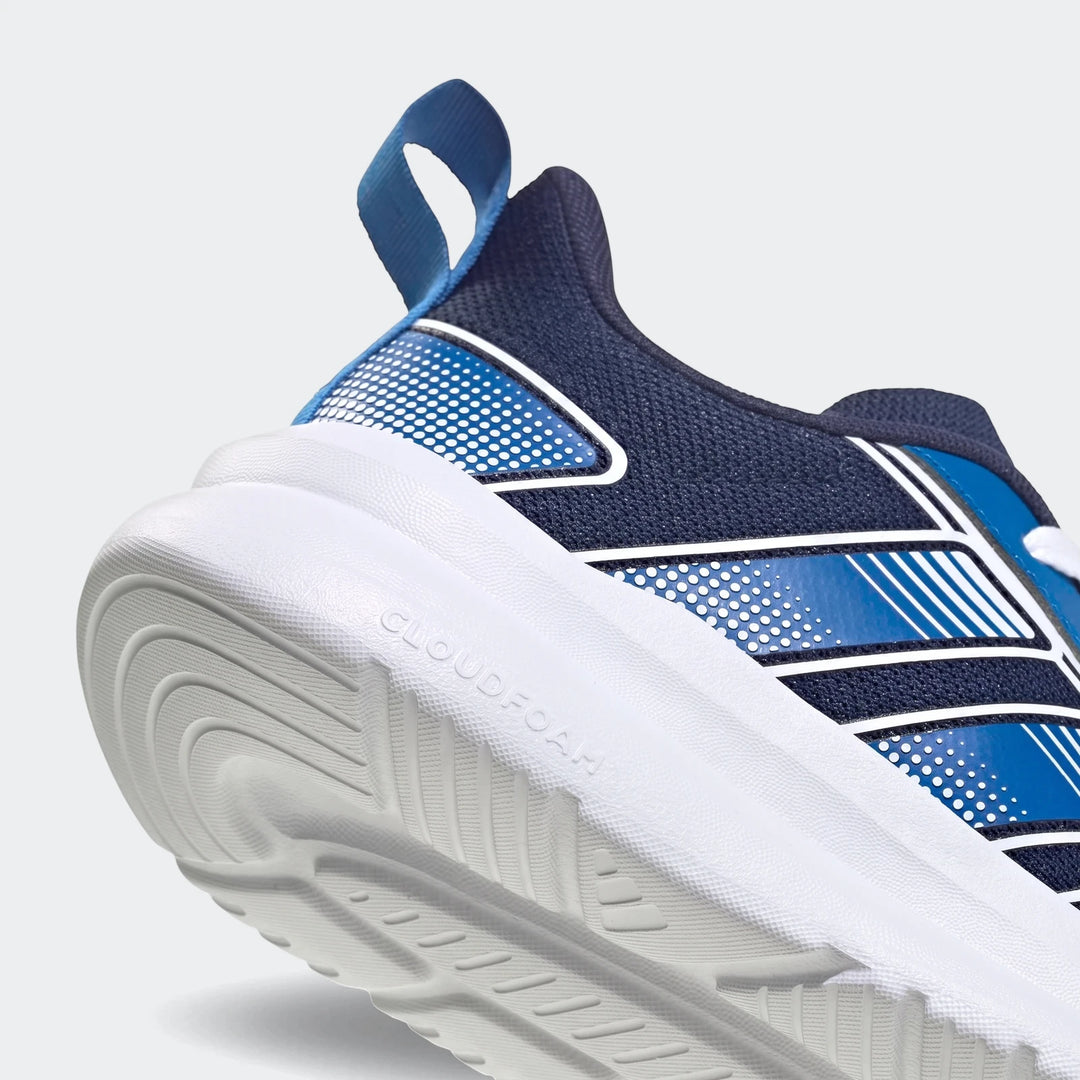 Close-up of a blue and white Adidas Tensaur Run 4.0 Junior shoe, highlighting the textured Cloudfoam sole and patterned