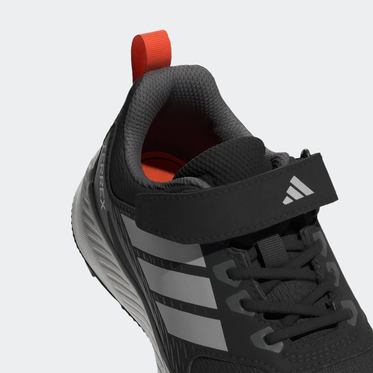 A close-up view of a black and grey Adidas Terrex Tracefinder Cf C shoe with an orange pull tab and a velcro strap.