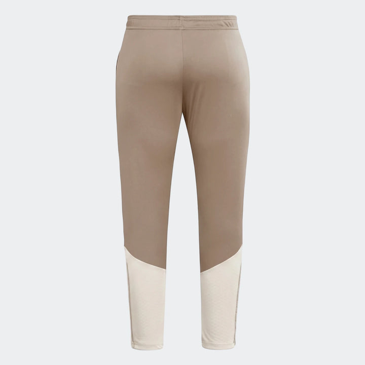 Back view of Tior26C brown athletic pants with off-white mesh panels and white side stripes.