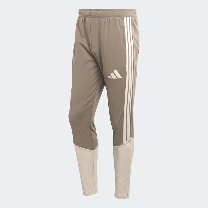 Tior26C men's brown and beige Adidas athletic pants, featuring three white stripes and an elastic waistband.