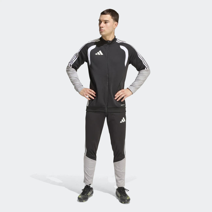 Male model in a full-body shot wearing a black and grey Adidas Tiro 26 Competition Training Jacket and matching tracksuit
