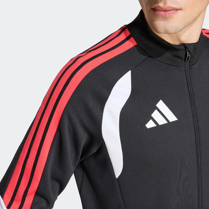 Close-up of a male model wearing a black Adidas Tiro 26 Competition Training Jacket with red shoulder stripes.