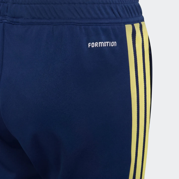 Close-up of navy blue Youth Adidas Tiro 26 Competition training pants with yellow stripes and a white FORMOTION logo.