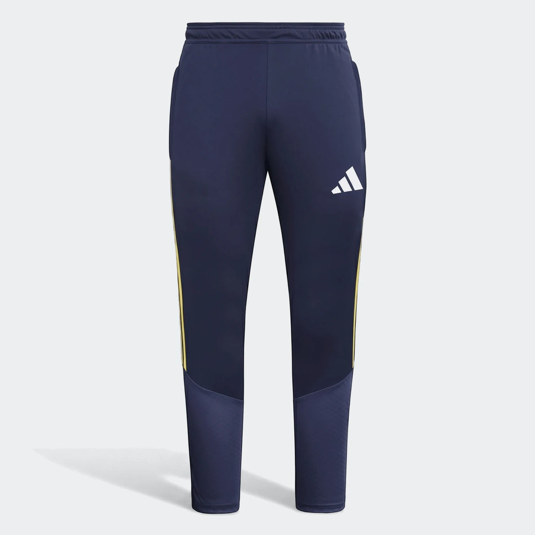 Tiro26 C navy blue track pants for men, featuring yellow side stripes and a white Adidas logo on the right thigh, presented