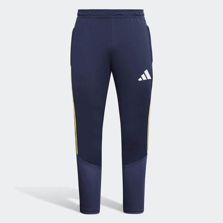 Tiro26 C navy blue track pants for men, featuring yellow side stripes and a white Adidas logo on the right thigh, presented