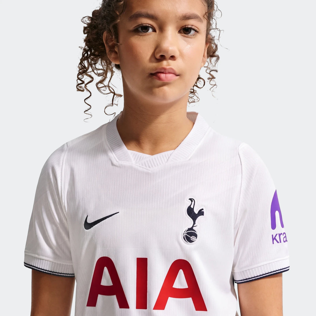 Young girl wearing a white Tottenham Hotspur 2026/27 Stadium Home Big Kids' Nike Dri-Fit Soccer Replica Jersey.