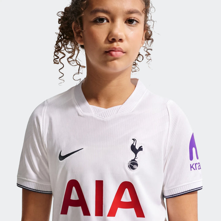 Young girl wearing a white Tottenham Hotspur 2026/27 Stadium Home Big Kids' Nike Dri-Fit Soccer Replica Jersey.