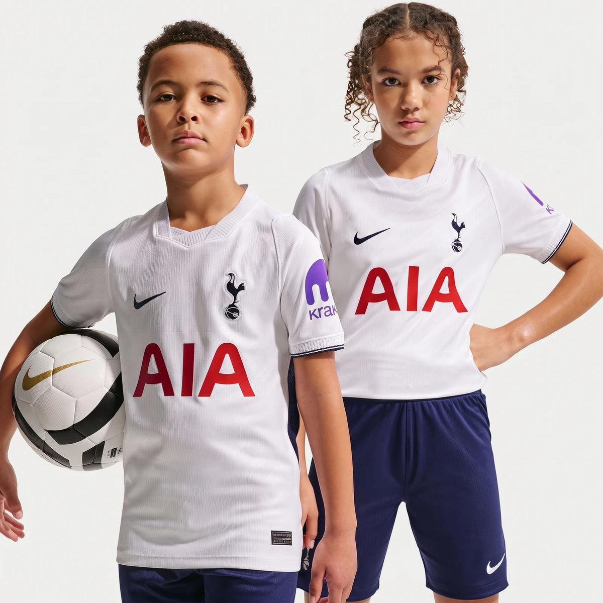 Two kids modeling the white Tottenham Hotspur 2026/27 Stadium Home Nike Dri-Fit Soccer Replica Jersey, with one holding a