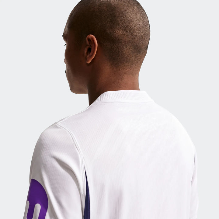 A man wearing a white Tottenham Hotspur 2026/27 Stadium Home Men's Nike Dri-Fit Soccer Replica Jersey, shown from the back