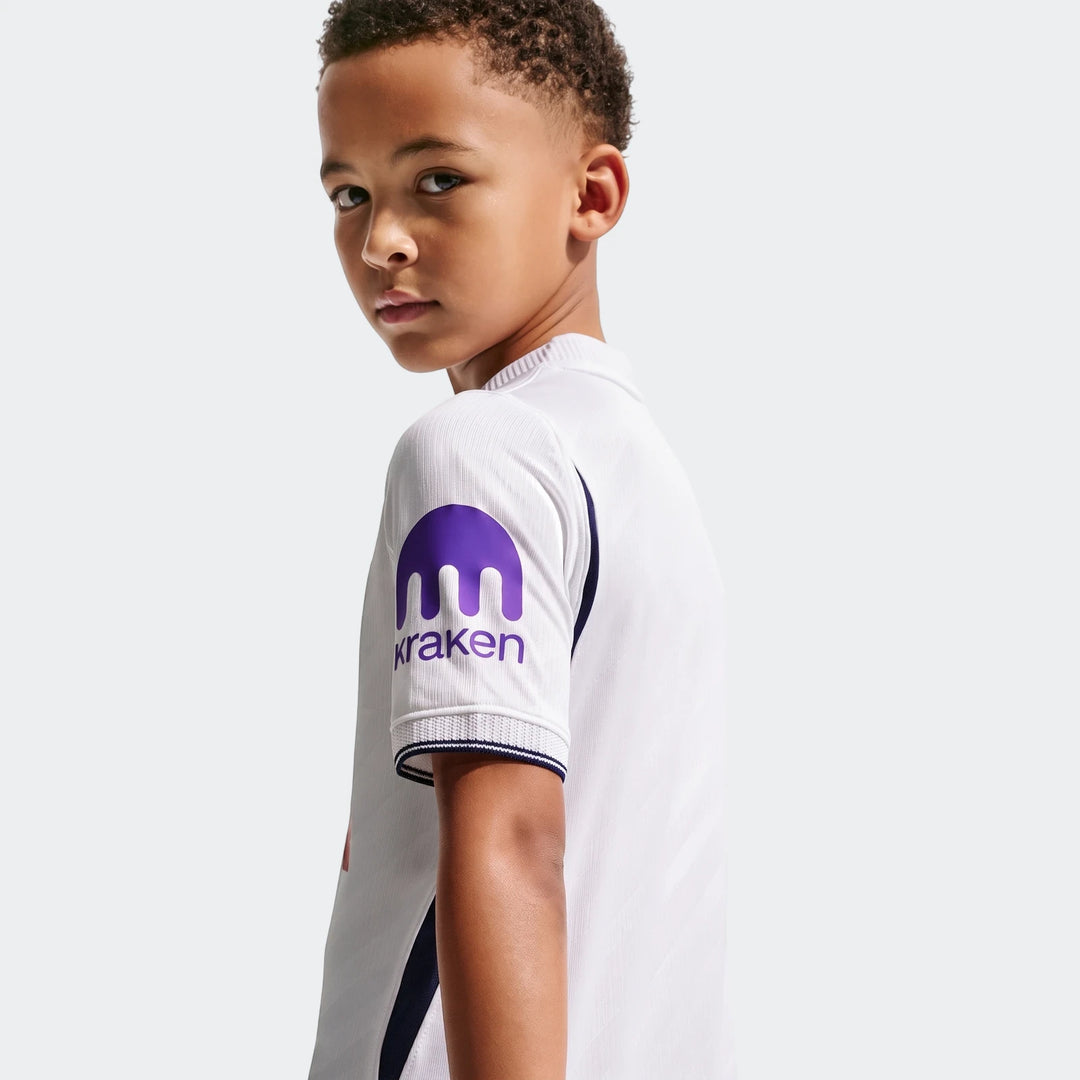 Young boy in white Tottenham Hotspur 2026/27 Stadium Home Nike Dri-Fit Soccer Replica Jersey with purple Kraken logo on