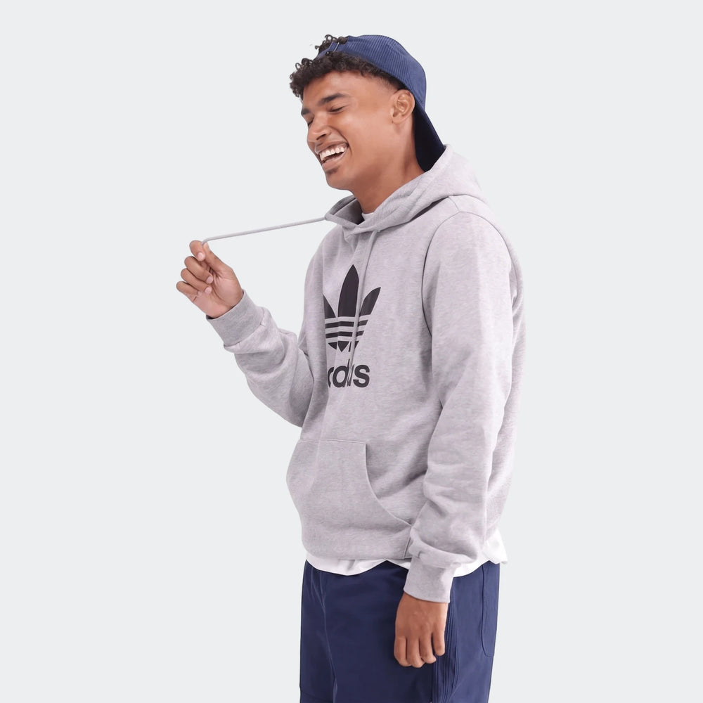 Trefoil Hoodie in light gray fleece with large front trefoil logo, pullover hood and kangaroo pocket, side view.