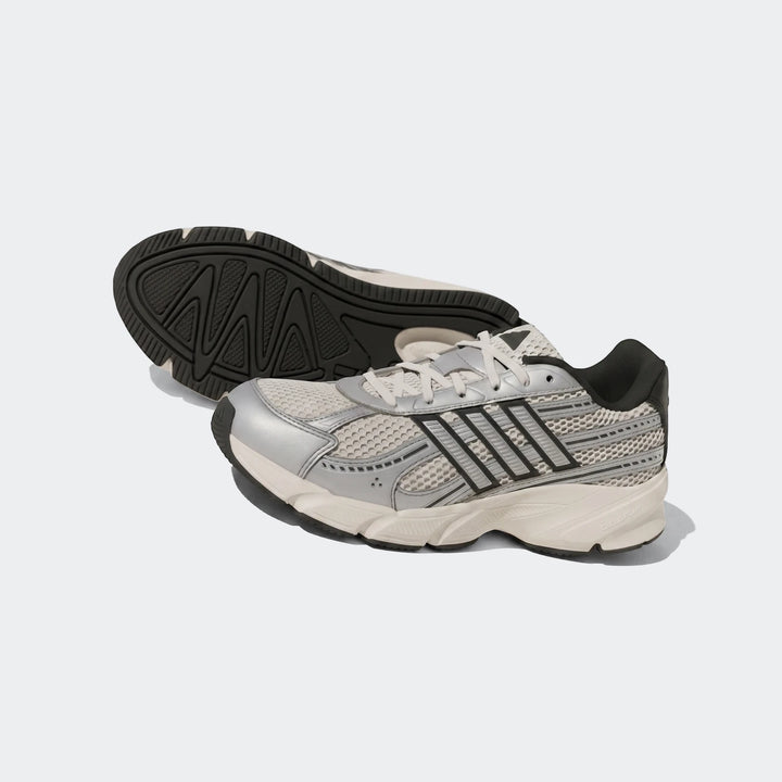 Pair of grey and white athletic sneakers with mesh and synthetic construction, featuring black striped branding on the side.